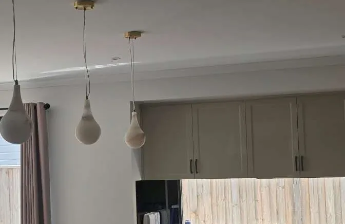 Anonymized kitchen upper cabinetry present during post-delivery fit-out.