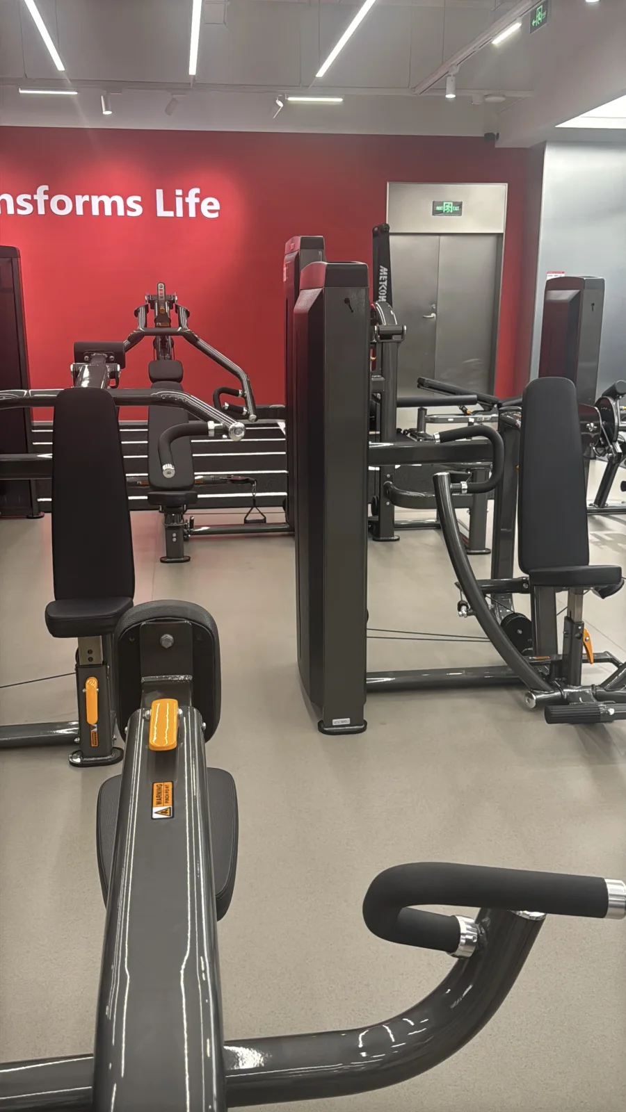 Vertical original field photograph of INSIGHT commercial strength equipment showing machine density, finish and circulation space.