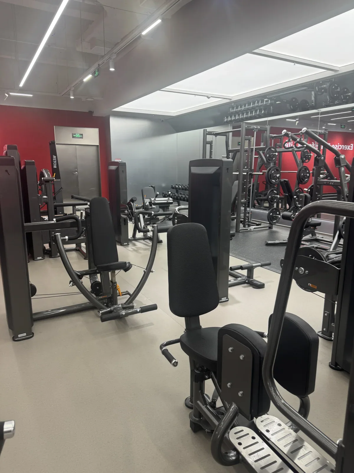 Original field photograph of INSIGHT selectorized strength equipment arranged in a commercial gym application site.